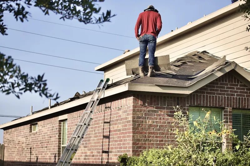 Professional roofer working on a residential roof in Poplar Point